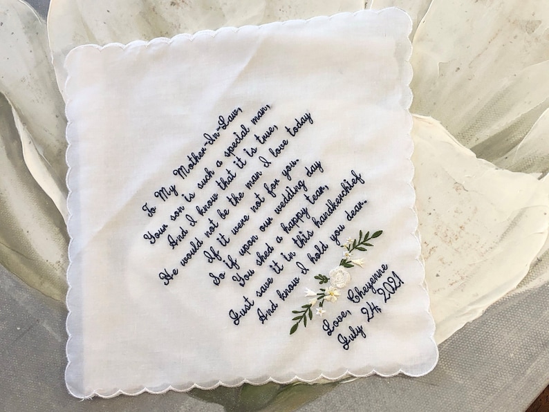 May include: White embroidered handkerchief with a handwritten message to a mother-in-law. The message reads "To My Mother-In-Law, Your son is such a special man, And I know that it is true, He would not be the man I love today If it were not for you. So if upon our wedding day You shed a happy tear, Do save it in this handkerchief And know I hold you dear. Love, Cheyenne July 24, 2021".