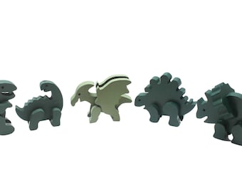 Dinosaur set with a brontosaurus, triceratops, pterodactyl, tyrannosaurus rex, and stegosaurus. Solid wood, painted green