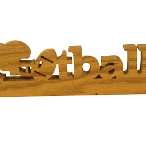 Football desk sign, with a helmet for the first letter &quot;o&quot; and a football for the second &quot;o.&quot; Cut from oak