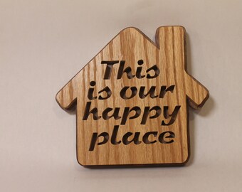 This is our happy place wall-hanging shaped like a house