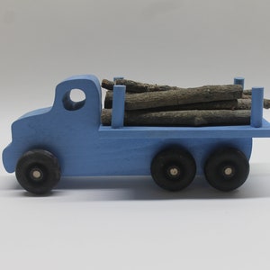 Logging truck, solid poplar, branches to simulate cut trees included