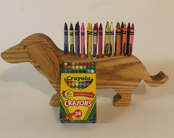 Dachshund shaped crayon holder. This cute holder provides a motivation for a child to put their crayons away