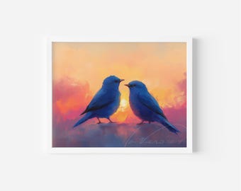 May include: A framed art print depicting two blue birds set against a sunset. The artwork uses a warm colour palette of orange, pink, and yellow, creating a tranquil and romantic scene. The artist's signature is visible.