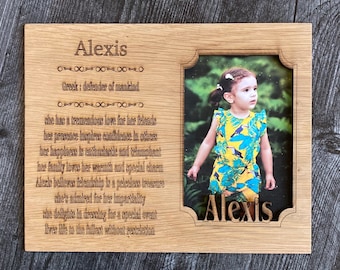 May include: A wooden plaque with a photo of a young girl and a personalized message. The plaque is engraved with the name "Alexis" and the text "Greek: defender of mankind". The message continues with a description of Alexis's personality and character traits.