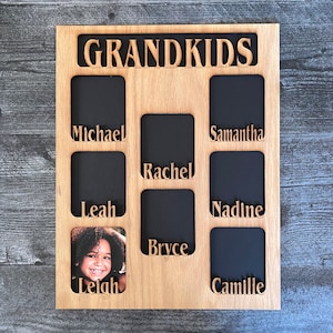 May include: A wooden photo frame with the word "GRANDKIDS" at the top. There are eight slots for photos, each with a name below: Michael, Samantha, Rachel, Nadine, Bryce, Camille, Leah, and Leigh.