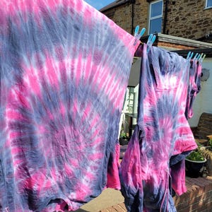 tie dye tees and tanks hanging on the washing line