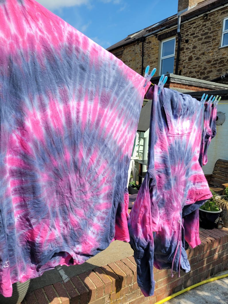 tie dye tees and tanks hanging on the washing line