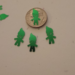 May include: Four green glitter troll figures, each about the size of a US dime.