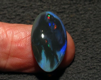 Stunning Black Opal from Mintabie Australia. Bright Rainbow flashes of color on Jet black. Unique and rare opal  7.05 Carat 22 x 13 x 4.5mm