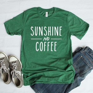 May include: Green t-shirt with the text "Sunshine and Coffee" in white lettering.