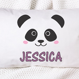 May include: White pillow with a black and white panda face and pink cheeks. The name "Jessica" is written in purple below the panda.