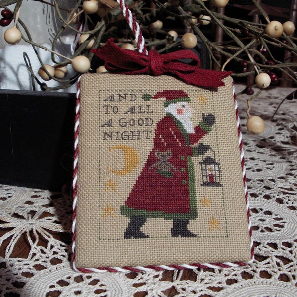 Finished primitive Santa counted cross stitch Christmas ornament