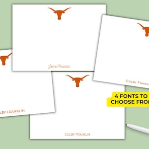 May include: White notecards with a burnt orange longhorn logo and personalized names in various fonts. The image shows four notecards with different names. A yellow banner reads "4 FONTS TO CHOOSE FROM". A white pen is in the bottom right corner.