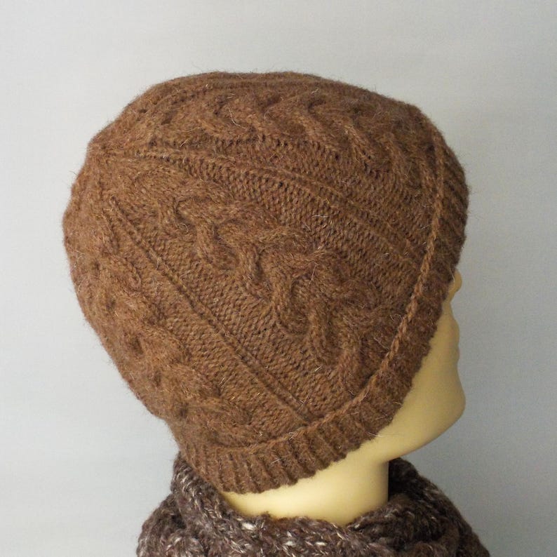 Cable design unisex beanie hat, hand-knit from rare breed Castlemilk Moorit wool at Roses Workshop. Shown with the welt turned up on a male model head. Back view to show cable detail. Natural undyed toffee brown pure British wool.