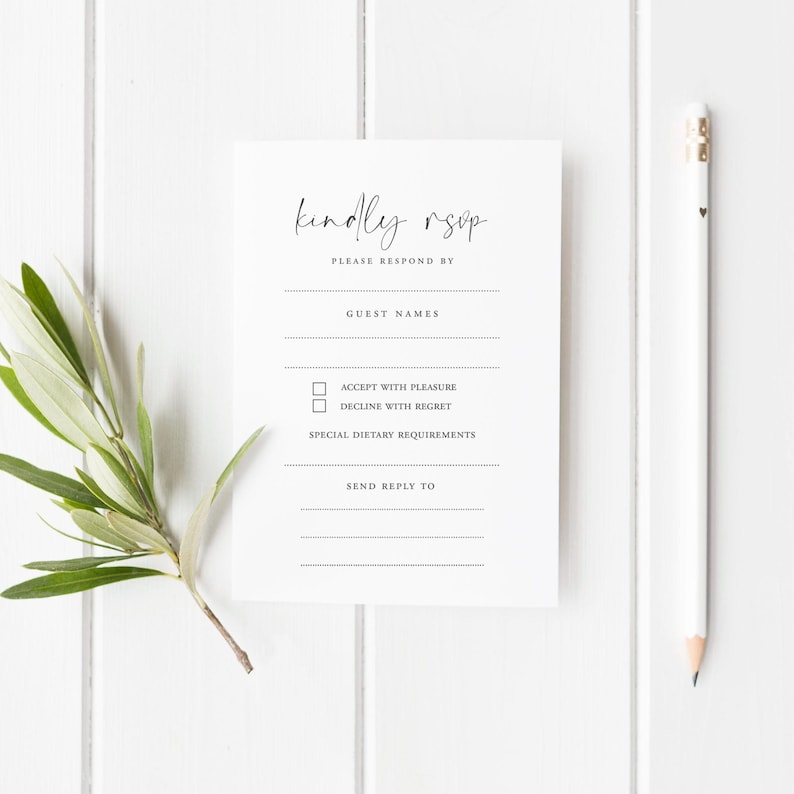 Minimalist printed RSVP card with the phrase “Nothing Fancy Just Reply!” in black modern typography, designed with fill-in-the-blank details for guest names, attendance, acceptance, dietary needs, and more. The card is placed on a white wooden background styled with white ranunculus flowers, gold vintage scissors, silk ribbon, and wooden spools – ideal for casual weddings, elopements, and budget-friendly celebrations with a simple, modern touch.