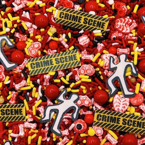May include: A mix of edible sprinkles featuring red, yellow, and black jimmies, red round sugar pearls, white bone-shaped candies, white human-shaped silhouettes, and rectangular yellow and black caution tape pieces printed with CRIME SCENE.