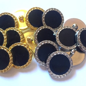 May include: A set of black buttons with gold and silver trim. The buttons are round and have a smooth, glossy finish.