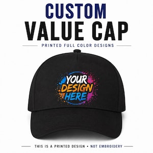 Può includere: Un cappellino da baseball nero con una grafica centrale composta da schizzi di vernice colorati e il testo "YOUR DESIGN HERE" in bianco, arancione e blu. Il testo "CUSTOM VALUE CAP" e "PRINTED FULL COLOR DESIGNS" appare sopra il cappellino.