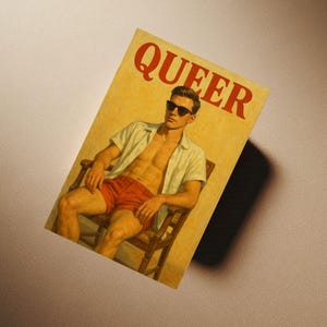 May include: A magazine cover with the word "QUEER" in red letters. The cover features a person wearing sunglasses, a white shirt, and red shorts, seated in a wooden chair. The background is a light yellow color.