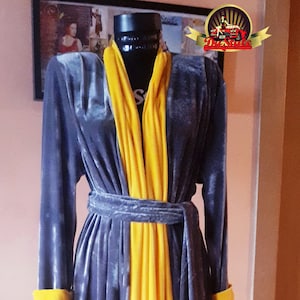 May include: A long, gray and yellow robe with a sash. The robe has a velvet texture and is tied at the waist.