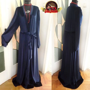 May include: A long, navy blue robe with a velvet trim and a tie belt. The robe has long sleeves and a V-neckline.