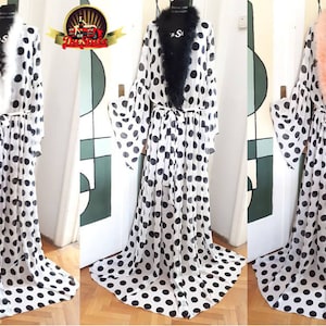 May include: Three white sheer robes with black polka dots and a fluffy trim around the collar. The robes have long sleeves and a tie at the waist.