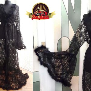 Puede incluir: Bata de encaje negro con mangas largas y ribete de plumas. La bata tiene un lazo en la cintura y una falda fluida.