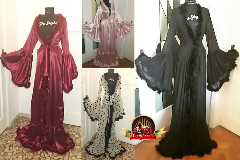 May include: Four long, flowing robes with feather trim. The robes are in pink, black, white with black polka dots, and burgundy. The robes have long sleeves with large, ruffled cuffs.