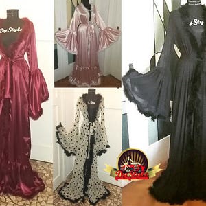 May include: Three long, flowing robes with black feather trim. The robes are in pink, black, and white with black polka dots. The robes have long sleeves with wide cuffs and a tie at the waist.