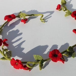 Glamorous tender little red poppy garland. A decoration for the inconspicuous lamp or the window sill