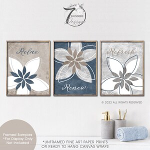 May include: Three framed bathroom prints with floral designs and the words "Relax", "Renew", and "Refresh".