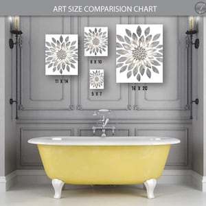 May include: A comparison chart showing different sizes of art prints featuring a gray and white floral design. The chart shows the prints in a bathroom setting above a yellow bathtub.