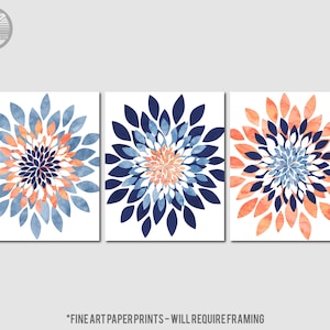 May include: Set of three abstract floral prints with a navy blue, coral, and white color scheme. The prints feature a stylized flower design with overlapping petals.