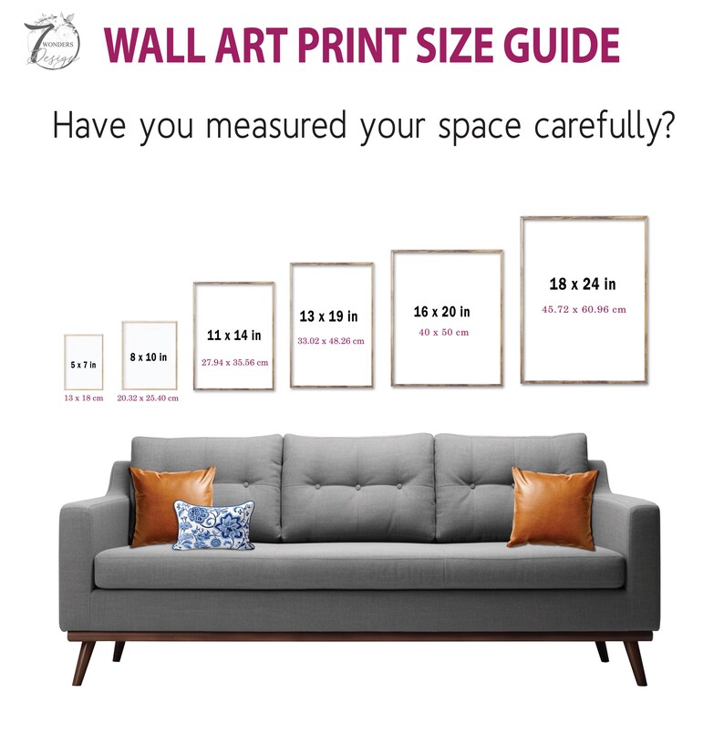 a couch with a pillow on top of it next to a wall art print size