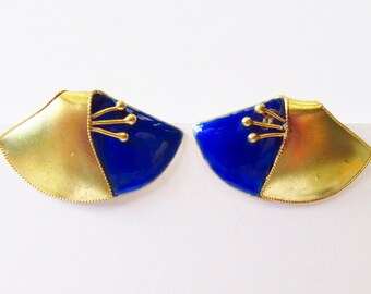 May include: A pair of gold and blue earrings with a geometric design. The earrings are shaped like a fan and have a gold accent in the center.