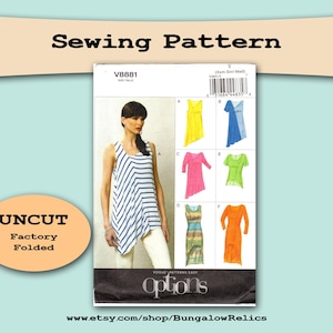 May include: A sewing pattern package with the text "Sewing Pattern" at the top. The package features a woman wearing a white and blue striped top. The package also shows several colorful dress designs. The text "UNCUT Factory Folded" is also visible.
