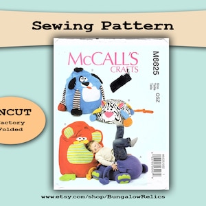 May include: An uncut McCall's Crafts sewing pattern for making stuffed animal bean bags. The pattern is for sizes OSZ and includes instructions for making a blue dog, a zebra, and a red and green monkey. The pattern is folded and has the title "McCall's Crafts" and the pattern number "M6625".