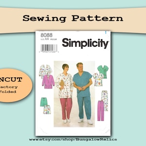 May include: Simplicity sewing pattern number 8088 for sizes XS, SM, and AA. The pattern is for a scrub top and pants set. The pattern is uncut and folded. The pattern is shown on a white background with a model wearing the scrub top and pants.