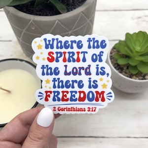 May include: A white sticker with red, white, and blue lettering that reads "Where the SPIRIT of the Lord is, there is FREEDOM" with stars and a lightning bolt design. The sticker also includes the scripture reference "2 Corinthians 3:17".