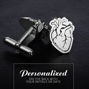 May include: Silver cufflinks with a heart design. The heart is detailed with lines and a textured finish. The cufflinks are personalized with your initials or date on the back.