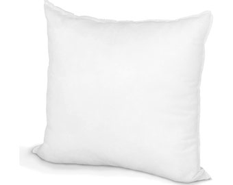 May include: A square, white pillow with a soft, puffy appearance. The pillow has a simple design with a clean, smooth surface and a textured edge. The pillow is likely used for sleeping or decorative purposes.