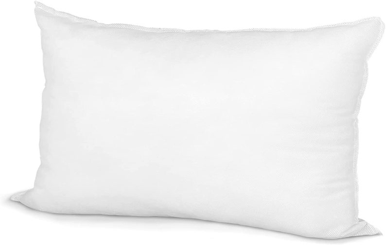 May include: A rectangular white pillow with a soft, puffy appearance. The pillow is made of a smooth fabric and has a seam around the edges. The pillow is designed for comfort and support, suitable for sleeping.