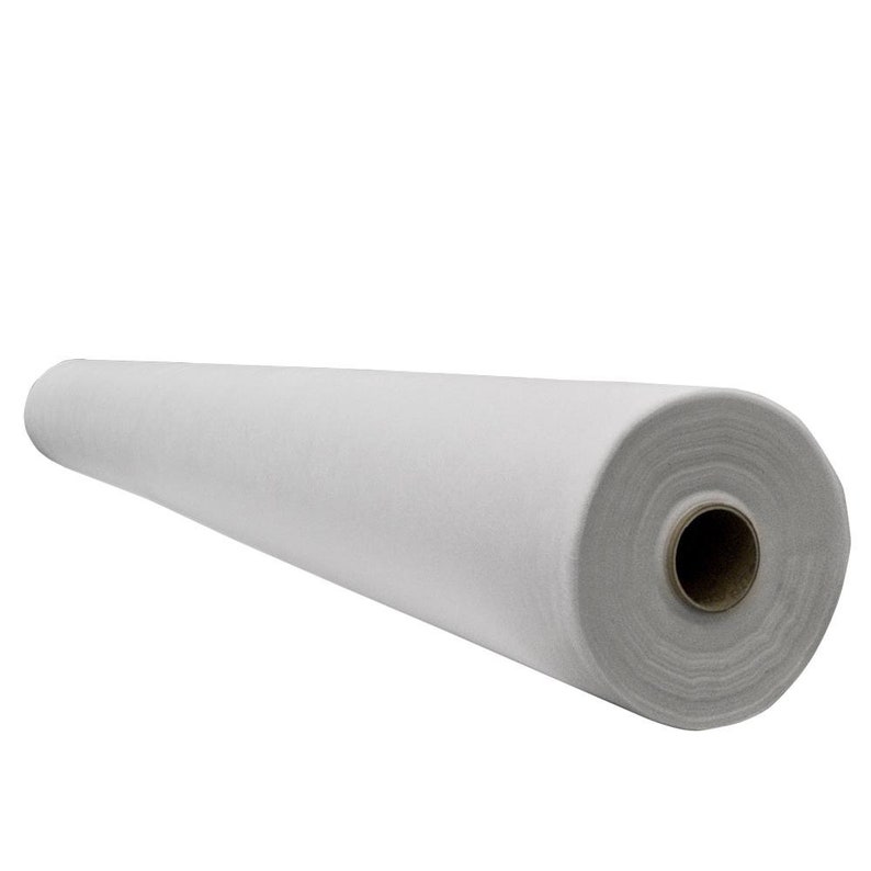 May include: A large roll of white felt fabric. The fabric is tightly rolled and appears to be made of a soft, non-woven material. The roll is cylindrical and has a cardboard core.