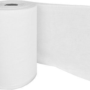 May include: A roll of white fabric, with a section unrolled to show its texture. The fabric is tightly wound into a cylindrical shape, with a portion unraveled to show its surface. The material appears to be soft and possibly absorbent.