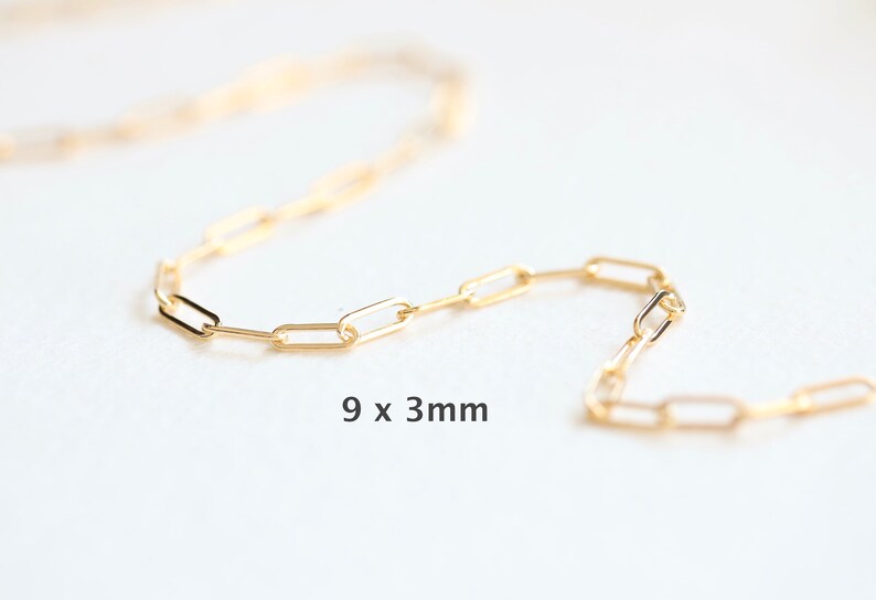 May include: A gold chain necklace with a 9 x 3 mm link pattern.
