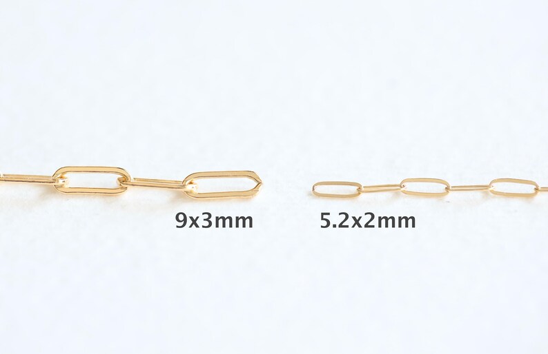 May include: Two gold chains with different sized links. The larger chain has links that are 9x3 mm and the smaller chain has links that are 5.2x2 mm.