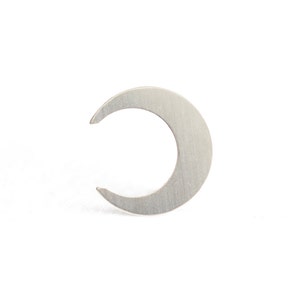 May include: A silver crescent moon shaped earring.