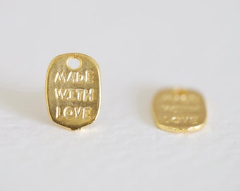 May include: Two gold-coloured metal tags with the words "Made with Love" embossed on them.