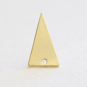 May include: A gold triangle charm with a small hole in the centre. The charm is flat and has a smooth surface.