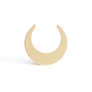 May include: A gold crescent moon shaped earring.